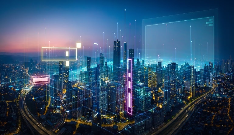 Aerial night view of a connected smart city with digital data overlays